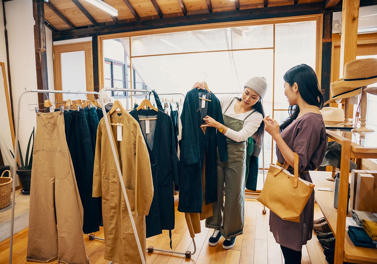 Two women shopping in a clothing store.